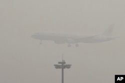 An Air China passenger plane prepares to land at the Beijing Capital International Airport as the capital of China through heavy smog, Dec. 21, 2016.