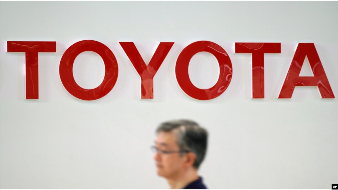 A visitor walks through a Toyota showroom in Tokyo, Aug. 3, 2018.