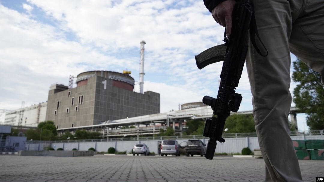 A security person stands in front of the Zaporizhzhia nuclear power plant, amid the ongoing Russian military action in Ukraine, Sept. 11, 2022. 