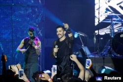 Hamed Sinno (R), the lead singer of Lebanese alternative rock band Mashrou' Leila performs during the Ehdeniyat International Festival in Ehden town, Lebanon, Aug. 12, 2017.