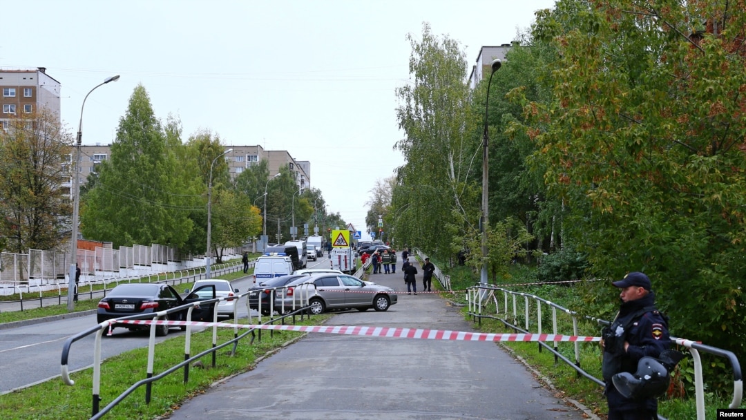 A police officer secures area after a school shooting in Izhevsk, Russia, Sept. 26, 2022.