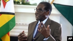 FILE - Zimbabwean President Robert Mugabe addresses his staff during a surprise birthday celebration event at State House in Harare, Feb. 22, 2016. Mugabe said Wednesday the country needs to rethink its indigenization policy. 