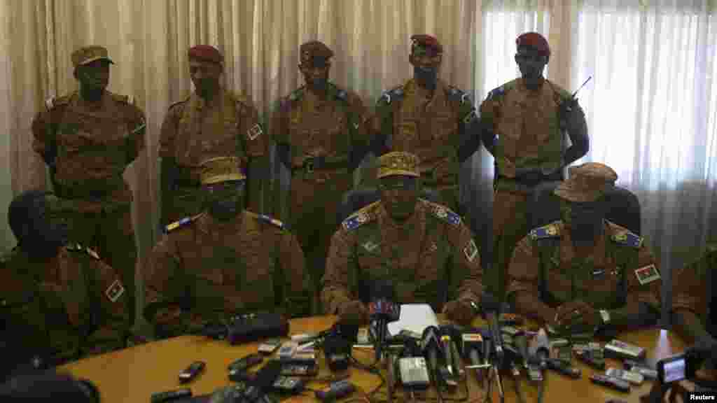Burkina Faso's military chief General Honore Traore, center, speaks at a news conference announcing his takeover of power at army headquarters in Ouagadougou, capital of Burkina Faso, Oct. 31, 2014.