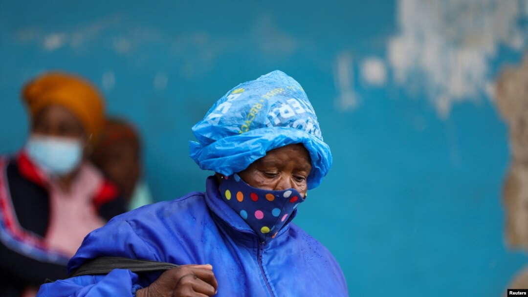 FILE - A woman wearing a protective face mask against the coronavirus disease (COVID-19) in Tsomo, a town in the Eastern Cape province of South Africa, Dec. 2, 2021.