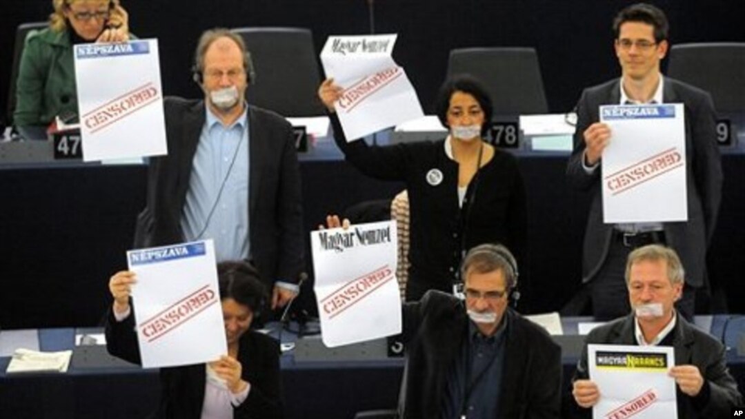 Parliament members protest as Hungary's Prime Minister Viktor Orban, unseen, delivers his speech at the European Parliament in Strasbourg, eastern France, 19 Jan. 2011