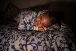 Tshimologo Bonolo, 8, poses for a photograph at her house in Soweto, South Africa, June 26, 2021. She lost her father to COVID-19 in July 2020.