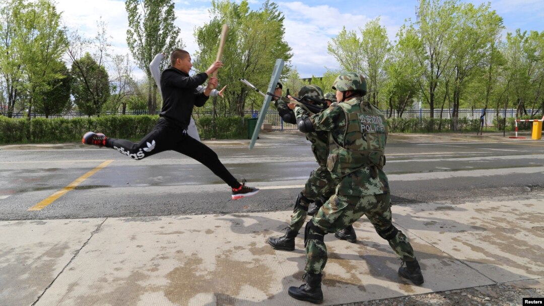 FILE - Border police take part in an anti-terrorism drill near Baketu border in Tacheng, Xinjiang Uighur Autonomous Region, China, April 28, 2016.