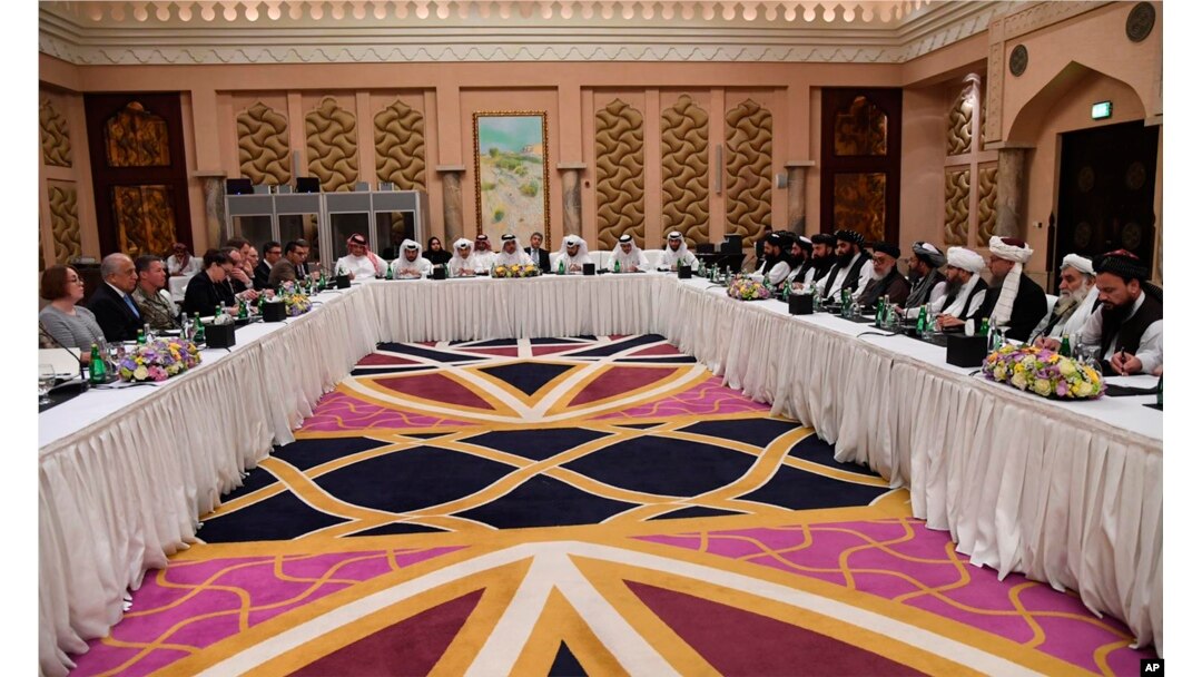 This photo released by Qatar's Ministry of Foreign Affairs shows Qatari, U.S. and Taliban officials conferring in an undisclosed place in Doha, Feb. 25, 2019.