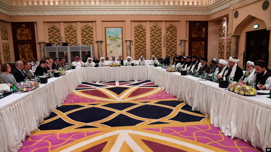 FILE - This photo released by Qatar's Ministry of Foreign Affairs shows Qatari, U.S. and Taliban officials conferring in an undisclosed place in Doha, Feb. 25, 2019.