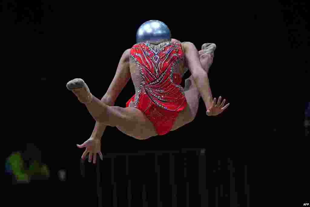 China's Zhao Yating competes with the ball in the women's rhythmic gymnastics individual all-around event during the 2018 Asian Games in Jakarta, Indonesia.
