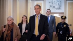 Mark Sandy, with the White House Office of Management and Budget, arrives at the Capitol to testify in the House impeachment inquiry about President Donald Trump's effort to tie military aid for Ukraine to probes of political opponents, Nov. 16, 2019. 