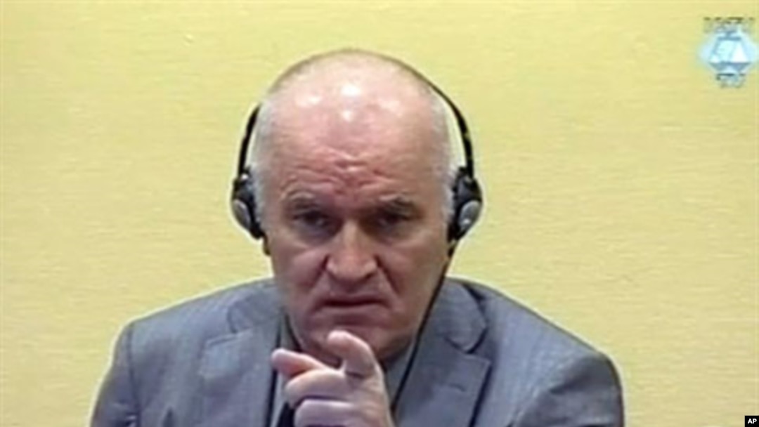Wartime Bosnian Serb army chief Ratko Mladic gestures at his long-awaited first appearance before a U.N. judge in The Hague, June 3, 2011
