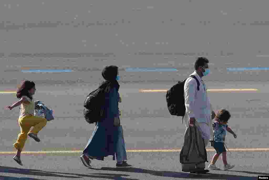 People who have been evacuated from Afghanistan after Taliban insurgents entered Afghanistan's capital Kabul, arrive at Melsbroek military airport Melsbroek, Belgium.