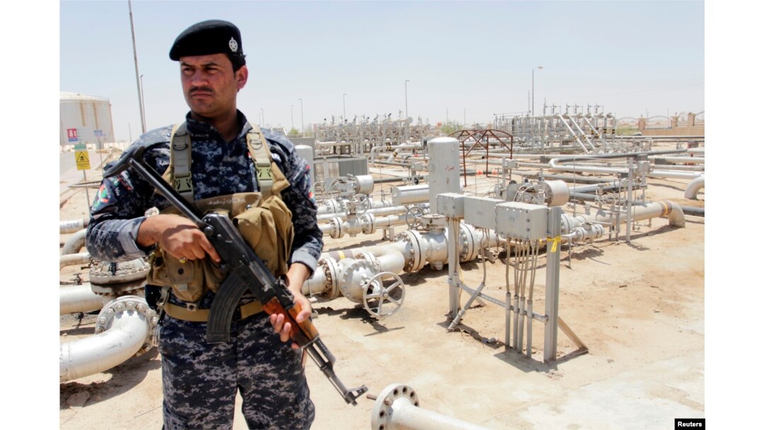 A member from the oil police force stands guard at Zubair oilfield in Basra, southeast of Baghdad, June 18, 2014.