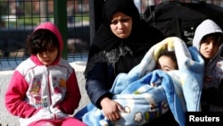 FILE - Migrants are pictured at a Turkish coastguard station in the Turkish coastal town of Dikili, after a failed attempt at crossing to the Greek island of Lesbos, April 6, 2016. Under a deal with the EU, Turkey has agreed to accept back migrants who enter neighboring Greece illegally.