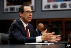 FILE - Treasury Secretary Steven Mnuchin testifies before a House Appropriations subcommittee, April 9, 2019, on Capitol Hill in Washington.