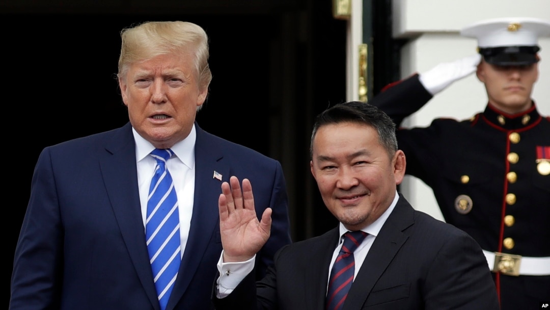 President Donald Trump greets Mongolian President Khaltmaa Battulga on the South Lawn of the White House, July 31, 2019, in Washington. 