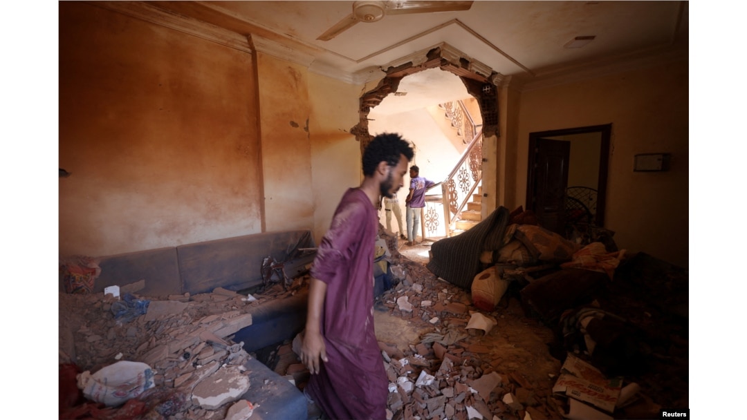 A man looks at the damage inside a house during clashes between the paramilitary Rapid Support Forces and the army in Khartoum, Sudan, April 17, 2023.
