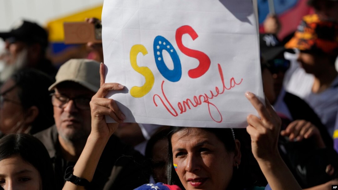 FILE - Venezuelan nationals attend a protest against the official results that declared President Nicolas Maduro the winner of the July presidential election, in Quito, Ecuador, Aug. 17, 2024.