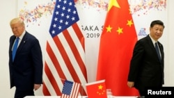 资料照：2019年6月29日，特朗普与中国领导人习近平在日本大阪出席G20国家领导人峰会期间举行双边会晤。