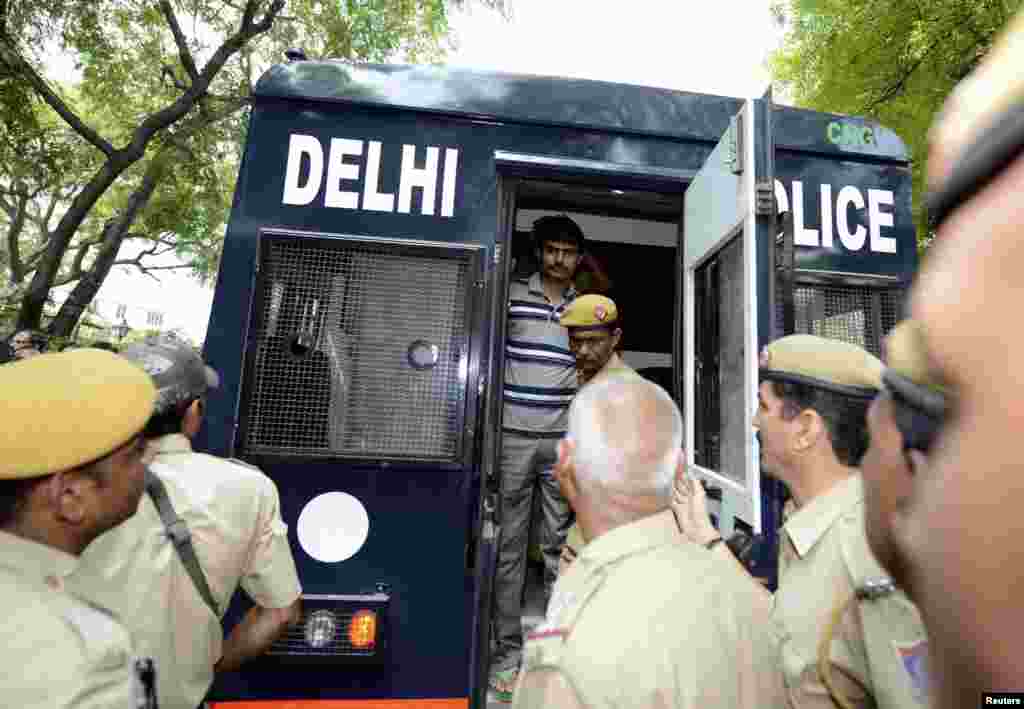 Akshay Thakur (top), one of the four men who were sentenced to death for the rape and murder of a young woman on a bus last December, disembarks a police vehicle outside a court in New Delhi, India.