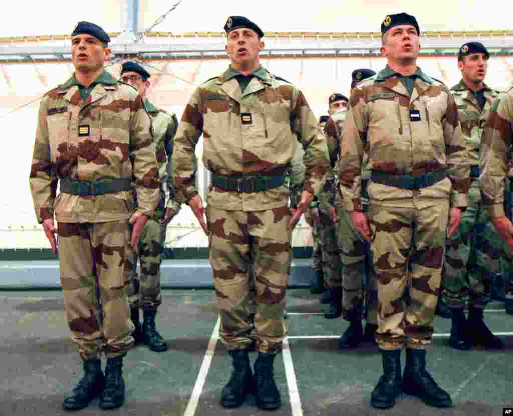 French soldiers sing the national anthem during a ceremony with French Defense Minister Jean-Yves Le Drian, before their departure to Mali, at Miramas Military base, France, January 25, 2013.