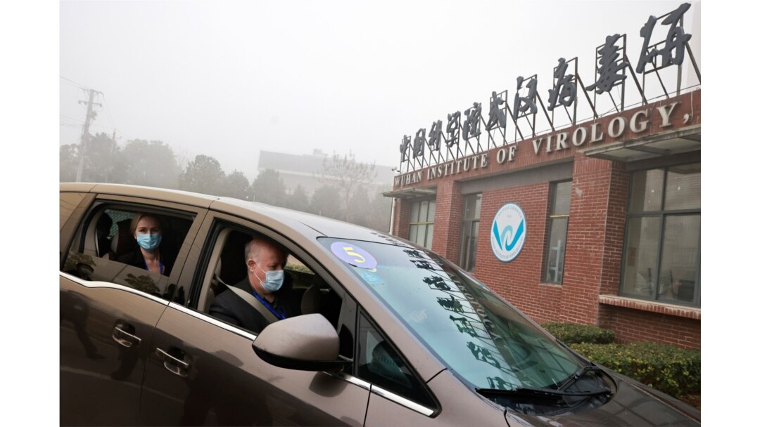 FILE - Peter Daszak and Thea Fischer, members of the World Health Organization team tasked with investigating the origins of the coronavirus disease, sit in a car arriving at Wuhan Institute of Virology in Wuhan, China, Feb. 2, 2021.
