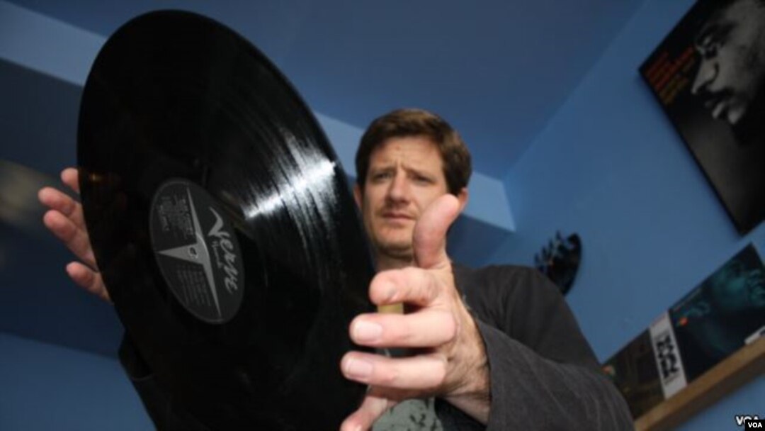 Kevin Stuart about to put another vinyl record on the turntable inside his Record Mad store in Johannesburg. (Darren Taylor for VOA News)