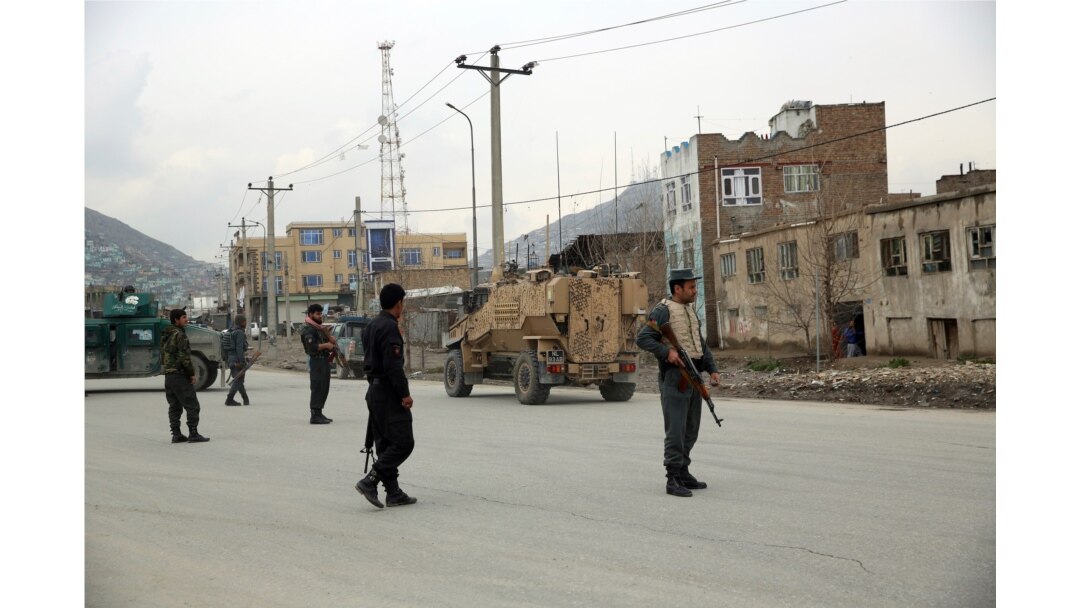 Afghan security personnel and British soldiers with NATO-led Resolute Support Mission forces arrive at the site of an attack in Kabul, March 25, 2020.