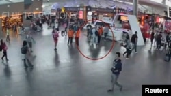 A still image from a CCTV footage appears to show a man purported to be Kim Jong Nam (circled in red) talking to airport staff, after being accosted by a woman in a white shirt, at Kuala Lumpur International Airport in Malaysia, Feb. 13, 2017. 