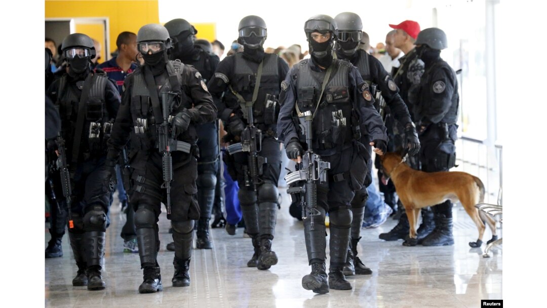 FILE - Members of Brazil's Battalion of Special Operations (BOPE) participate during a crisis simulation exercise to show the media how security will be provided during the 2016 Olympics in Rio de Janeiro, Brazil, Feb. 11, 2015.