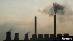 FILE - Smoke rises from the Duvha coal-based power station owned by state power utility Eskom, in Mpumalanga province, South Africa, Feb. 18, 2020. 