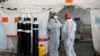 Healthcare workers chat at a temporary ward set up during the coronavirus disease (COVID-19) outbreak, at Steve Biko Academic Hospital in Pretoria, South Africa, January 19, 2021.