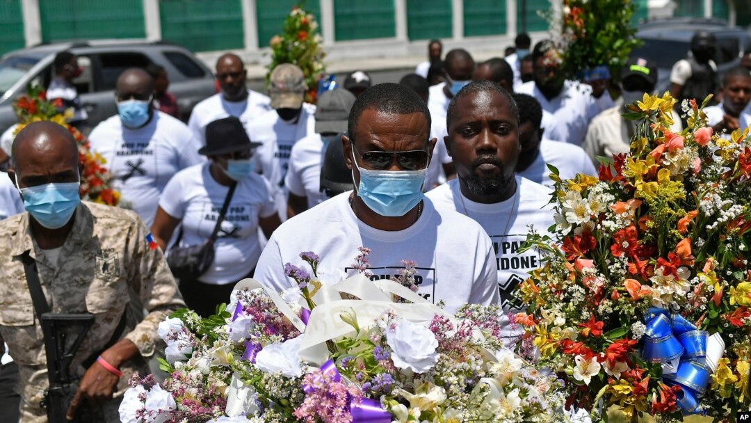 Pierre Gary Bernadotte, a member of the slain president's PHTK political party, carries flowers to a spot outside the presidential palace in memory of the late President Jovenel Moise in Port-au-Prince, Haiti, July 14, 2021.