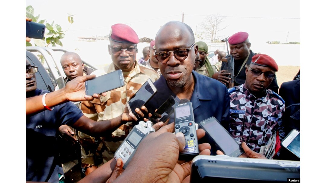 FILE - Ivory Coast's Minister of Defence Alain-Richard Donwahi speaks to the media as he arrives to speak with mutinous soldiers in Bouake, Ivory Coast, Jan. 7, 2017.