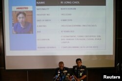Malaysia's National Police Deputy Inspector-General Noor Rashid Ibrahim (front left) speaks in front of a screen showing detained North Korean Ri Jong Chol during a news conference regarding the apparent assassination of Kim Jong Nam.