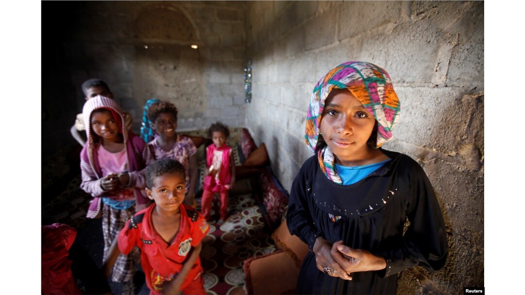 FILE - Children displaced from the Red Sea port city of Hodeida stand in their shelter in Sana'a, Yemen, Nov. 1, 2018.