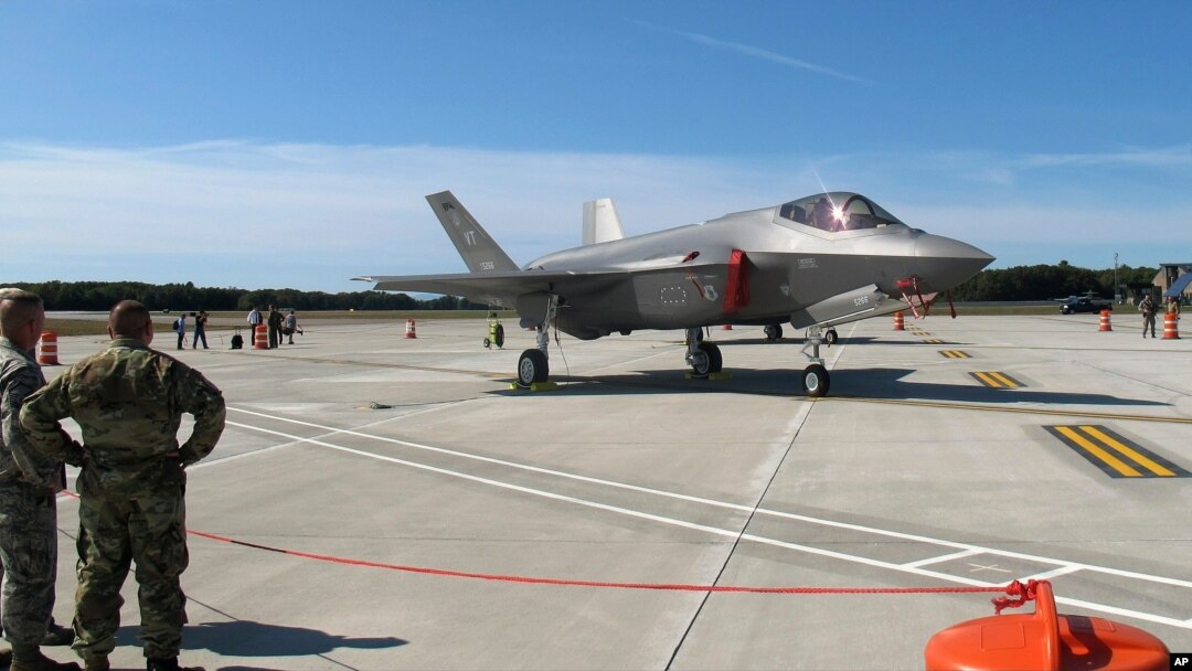 FILE - In this Sept. 19, 2019, photo, National Guard members, left, view the first two F-35 fighter jets that arrived at the Vermont Air National Guard base in South Burlington, Vt.