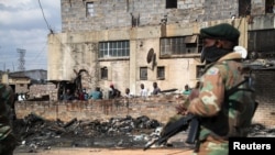FILE - Members of the military patrol through the streets of Alexandra township as the country deploys the army to quell unrest linked to the jailing of former President Jacob Zuma, in Johannesburg, South Africa, July 15, 2021. 