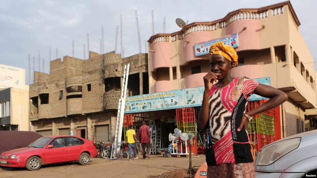 FILE - A girl waits to cross a street in Bamako, Mali, April 11, 2016.