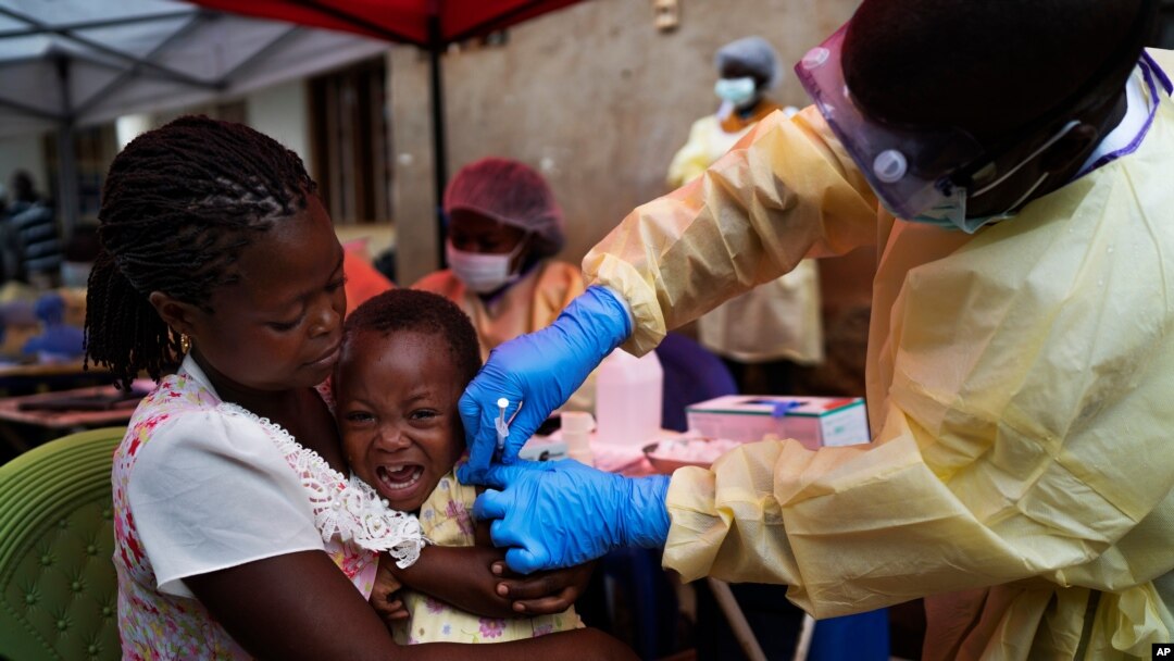 FILE - A child is vaccinated against Ebola in Beni, Congo, July 13, 2019.