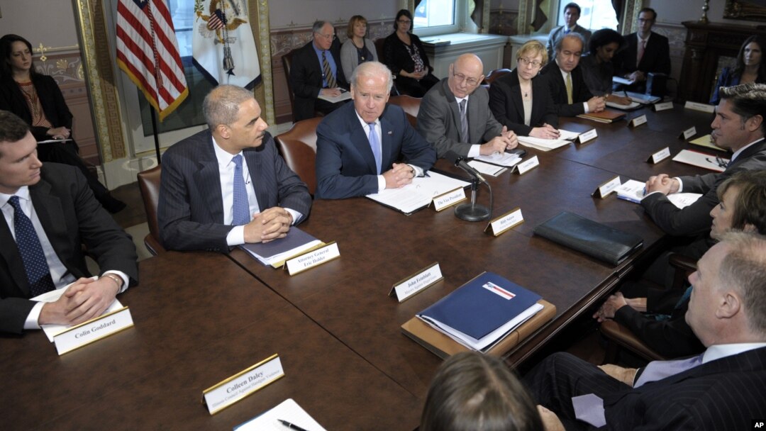 Vice President Joe Biden, center, with Attorney General Eric Holder at left, speaks during a meeting with victims' groups and gun safety organizations in the Eisenhower Executive Office Building on the White House complex in Washington, Wednesday, Jan. 9,