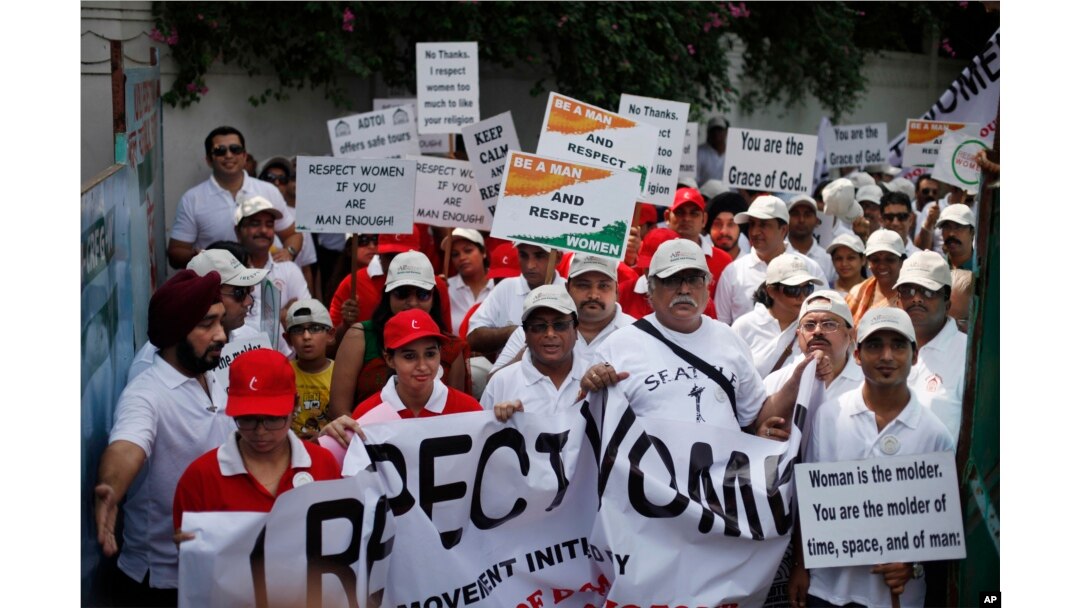 FILE - Indian people march during a "I Respect Women" walk for gender equality in New Delhi, India.
