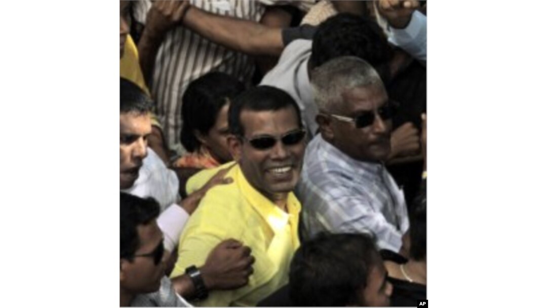 Mohamed Nasheed, center, who resigned Tuesday from his post as Maldivian president, marches along with his supporters during a rally in Male, Maldives, February 8, 2012.