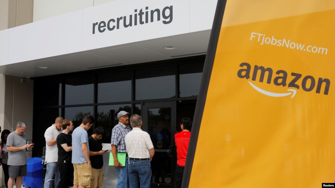 Job seekers line up to apply during "Amazon Jobs Day," a job fair being held at 10 fulfillment centers across the United States aimed at filling more than 50,000 jobs, at the Amazon.com Fulfillment Center in Fall River, Massachusetts, Aug. 2, 2017. 
