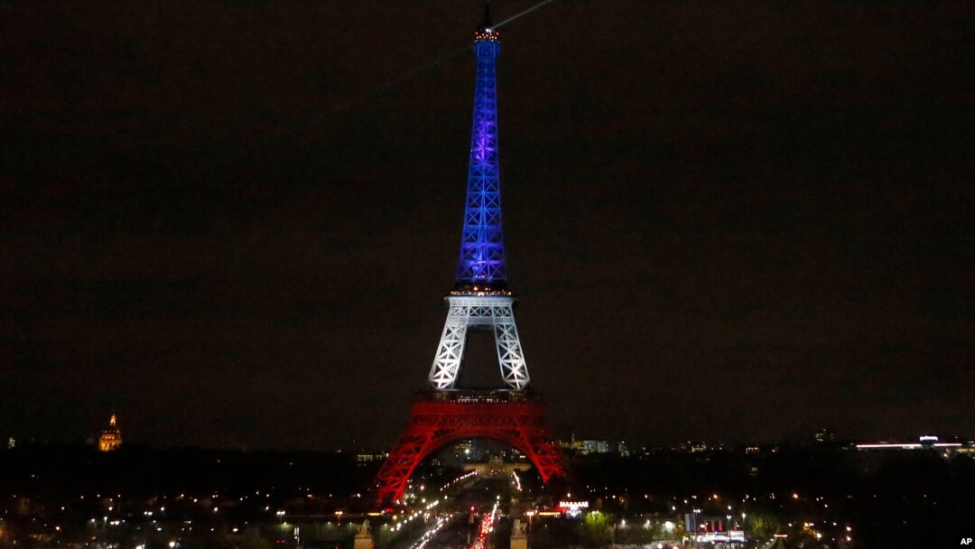 The Eiffel Tower is illuminated in the French national colors red, white and blue in honor of the victims of the terror attacks last Friday in Paris, Monday, Nov. 16, 2015. 