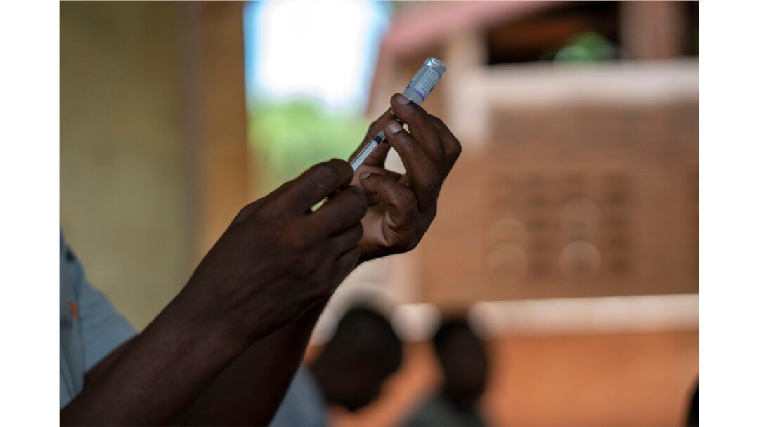 FILE - In this file photo taken Wednesday, Dec. 11, 2019, health officials prepare to vaccine residents of the Malawi village of Tomali, where young children become test subjects for the world's first vaccine against malaria.