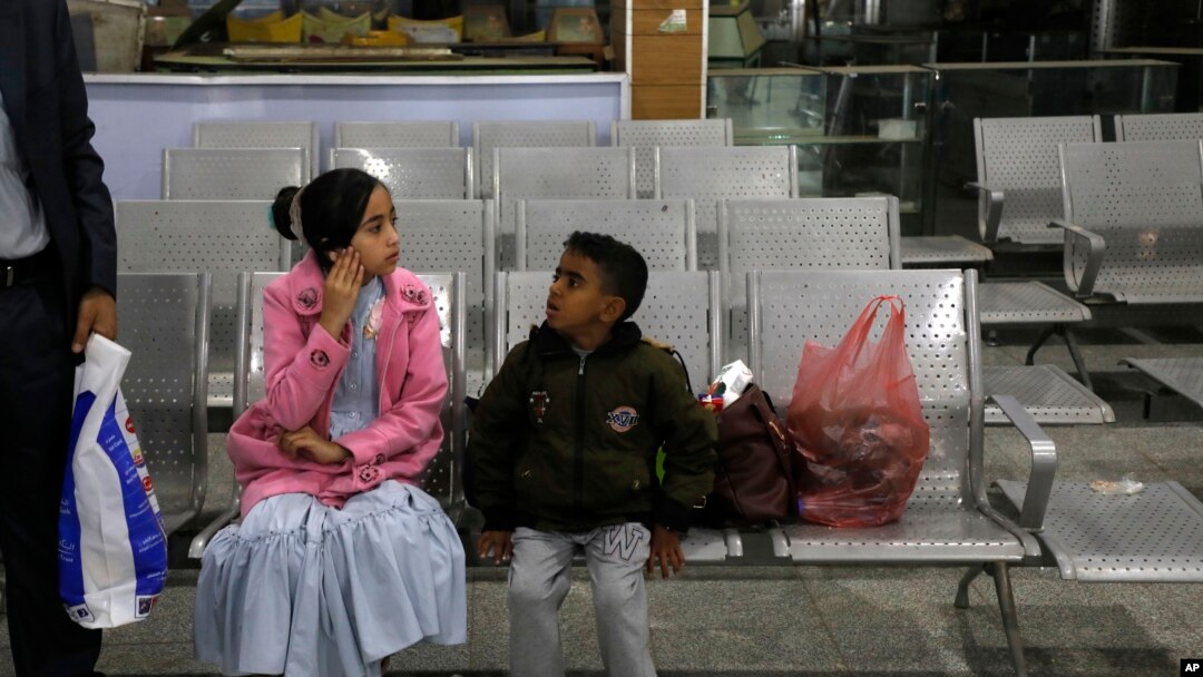 A Yemeni girl and boy wait in the departure lounge at Sana'a International airport, in Yemen, Feb. 3, 2020. A United Nations medical relief flight carrying patients from Yemen's rebel-held capital took off Monday.