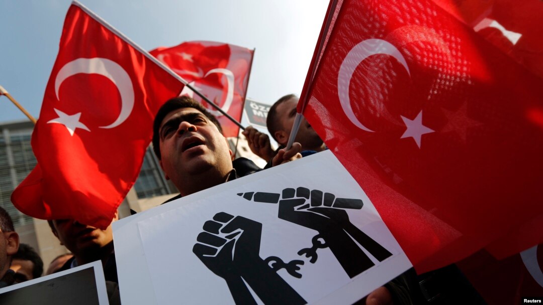 Supporters of the Gulen movement wave Turkish flags as they gather outside the Justice Palace in Istanbul, Dec. 19, 2014.