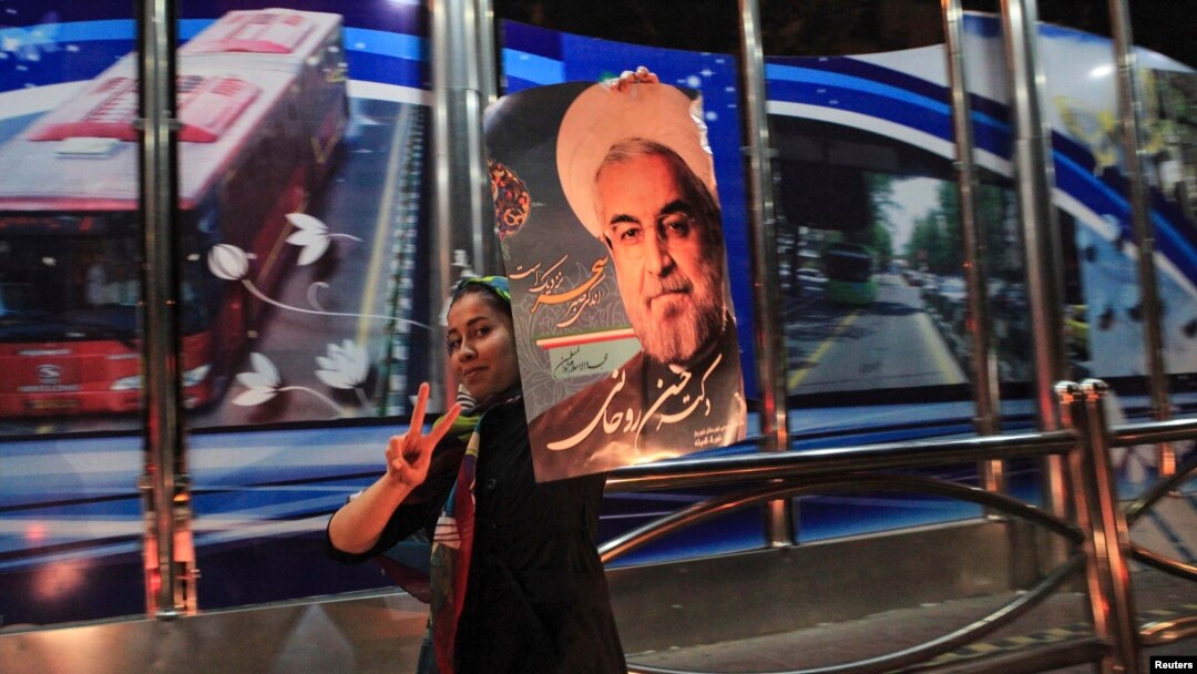 A supporter of moderate cleric Hassan Rohani celebrates his victory in Iran's presidential election along a street in Tehran, June 16, 2013.